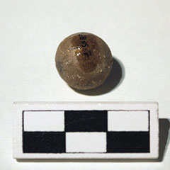 Colour photograph of a lead bullet and its Borden Code.