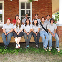 Colour photograph of the archaeological team sitting on a balcony.